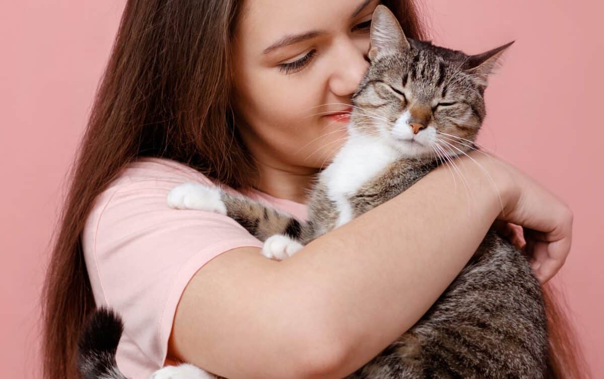 Cat held very close to girl's face