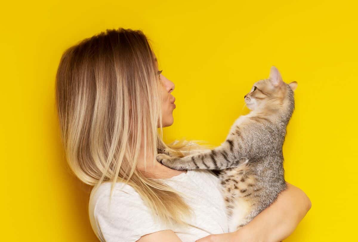 Woman looking into cat's eyes