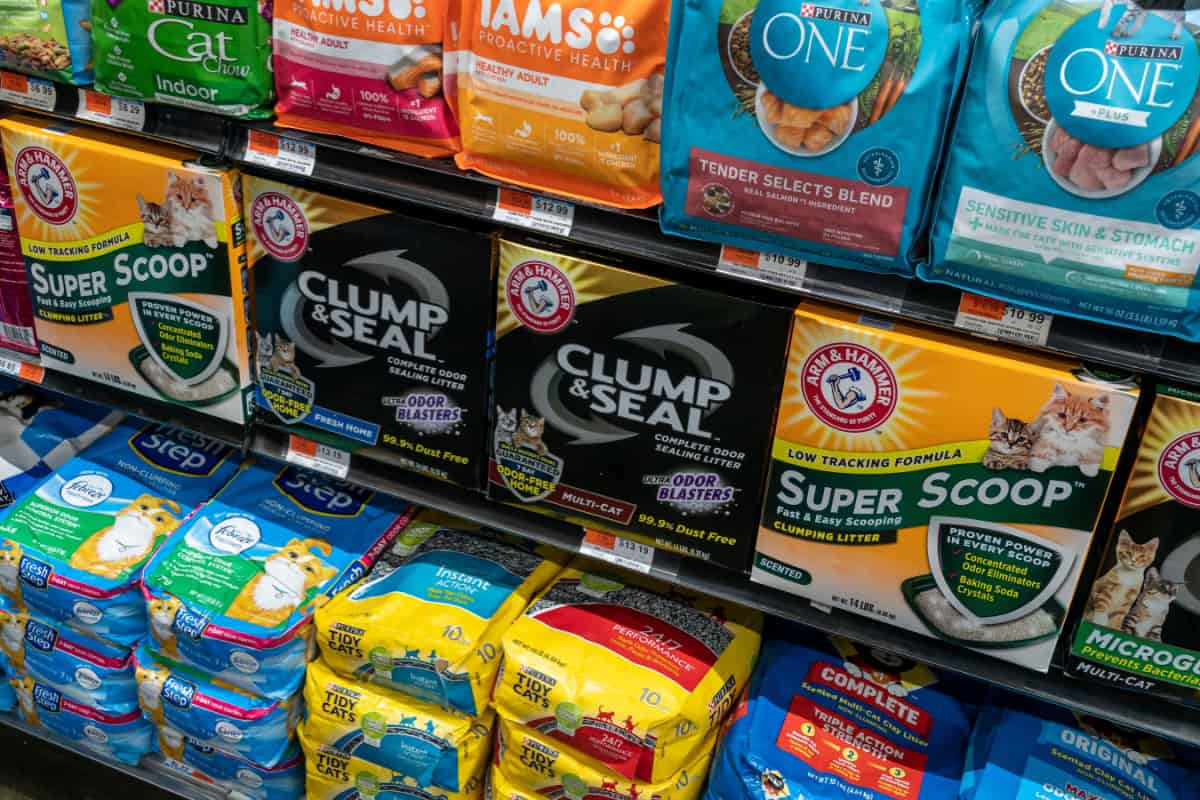 collection of cat litter and cat food on supermarket shelves