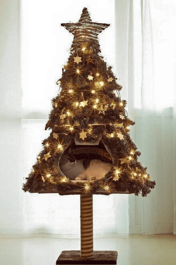 cat lounging inside the Christmas tree